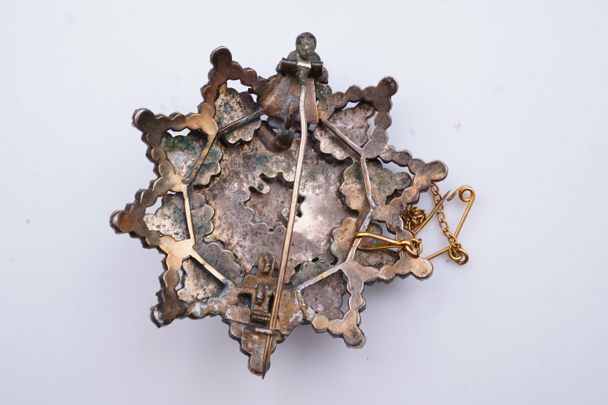 A suite of garnet and paste jewellery, comprising: a brooch, 5cm diameter; a bangle, inner circumference 16cm; two rings, sizes I and M; a pair of earrings, and a single earring, each set with rose-cut garnets; and a pai